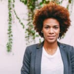 portrait of woman standing in front of ivy background