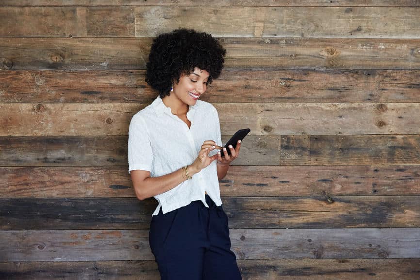 businesswoman in office looking at mobile phone