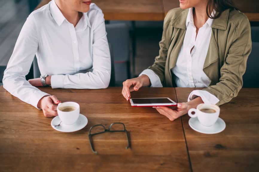 two women having coffee and business meeting in restaurant